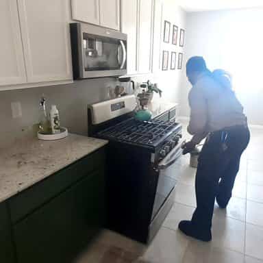 Residential pest control in Las Vegas - Bug insect spray of home kitchen appliance rear of stove